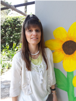 Georgina beside the sunflower mural