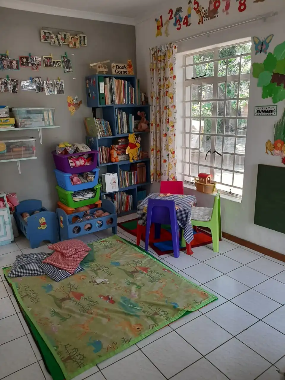 Book corner, dolls, and play mats in the classroom